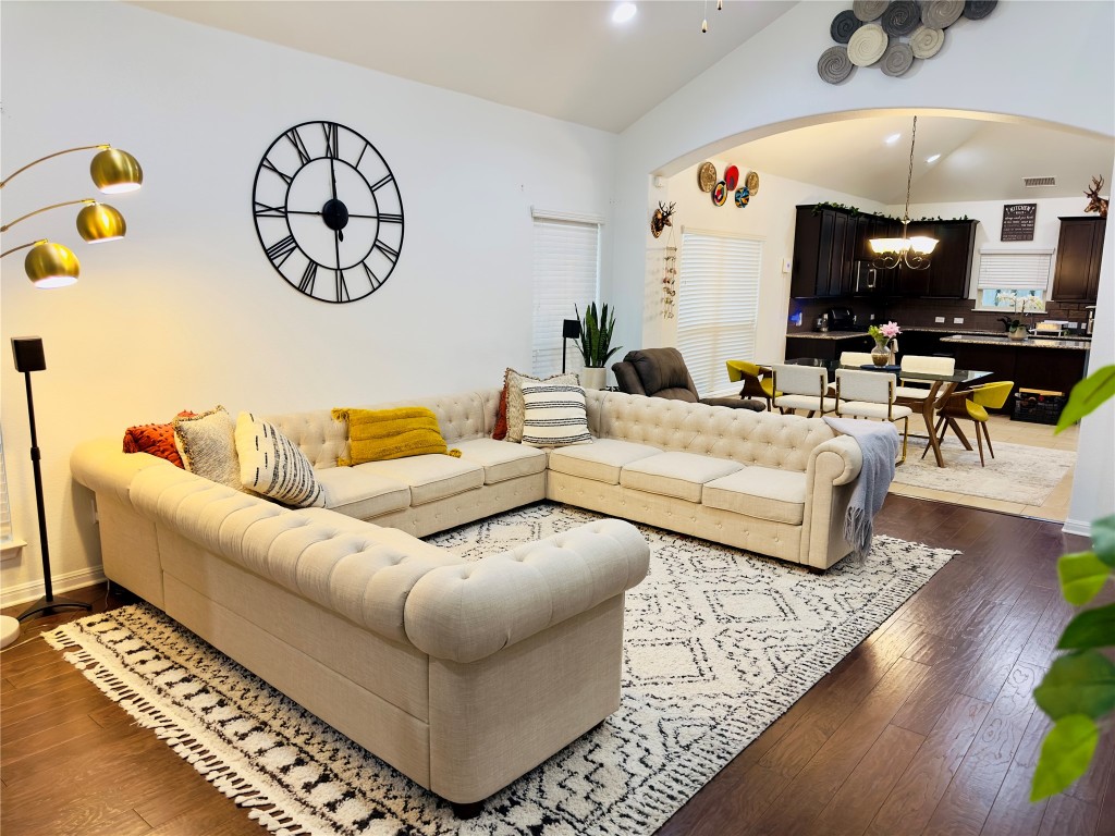 a living room with furniture and wooden floor