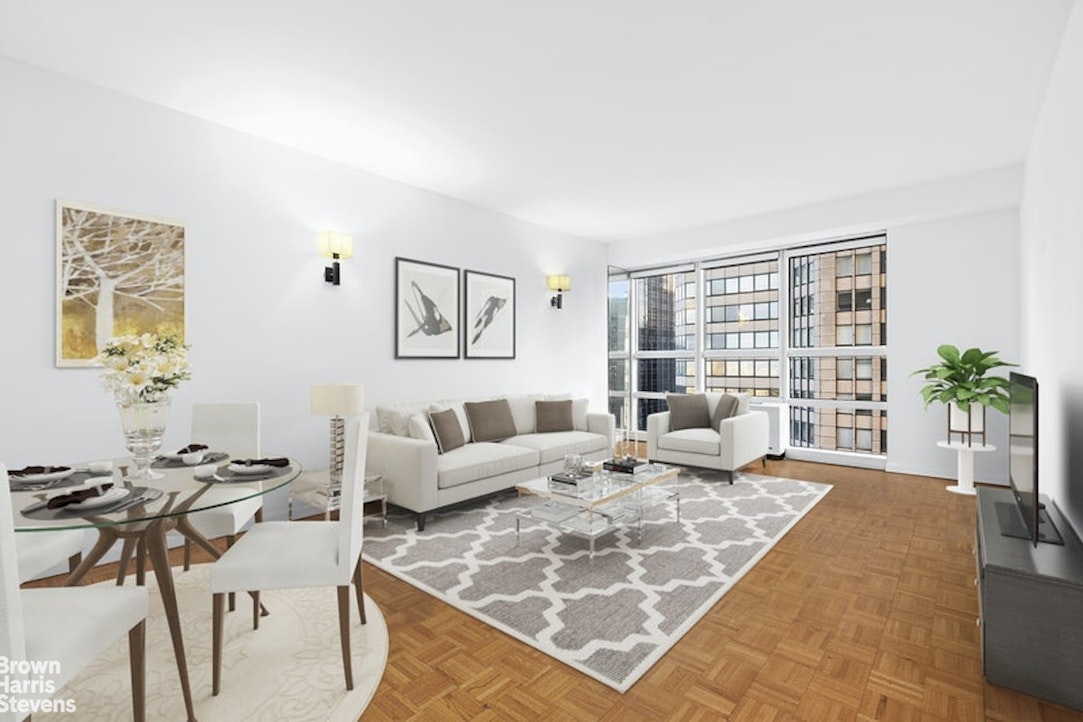 a living room with furniture large window and table