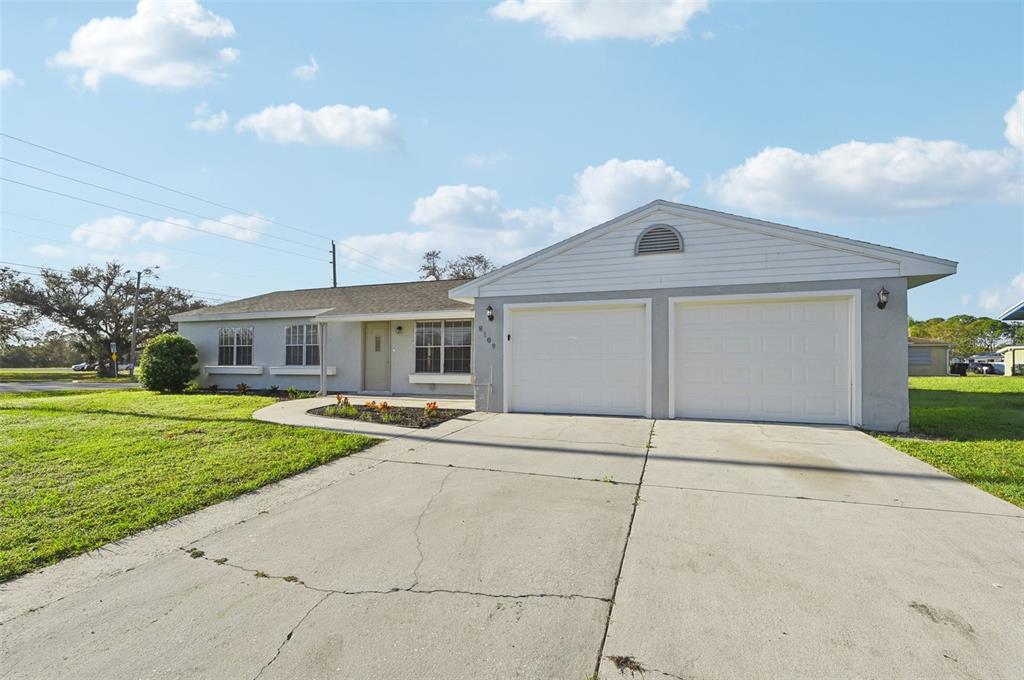 a front view of a house with a yard and garage