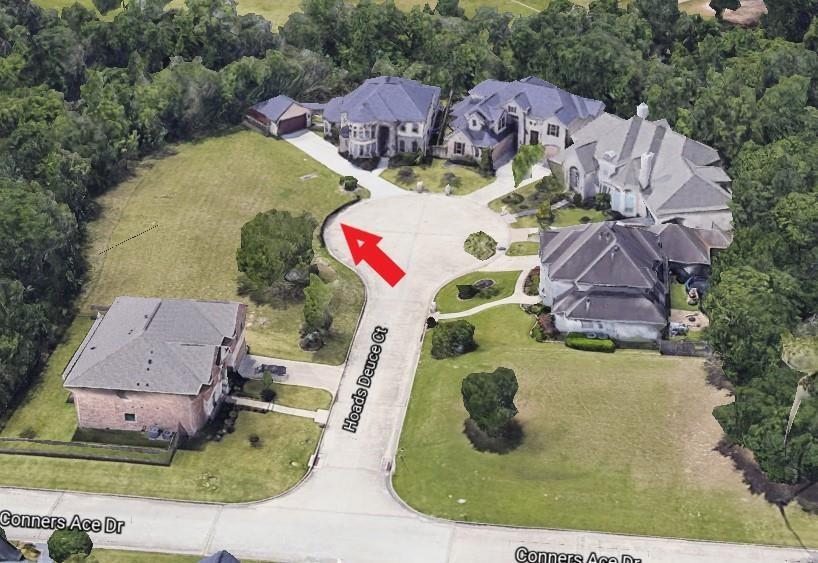 an aerial view of a house with yard