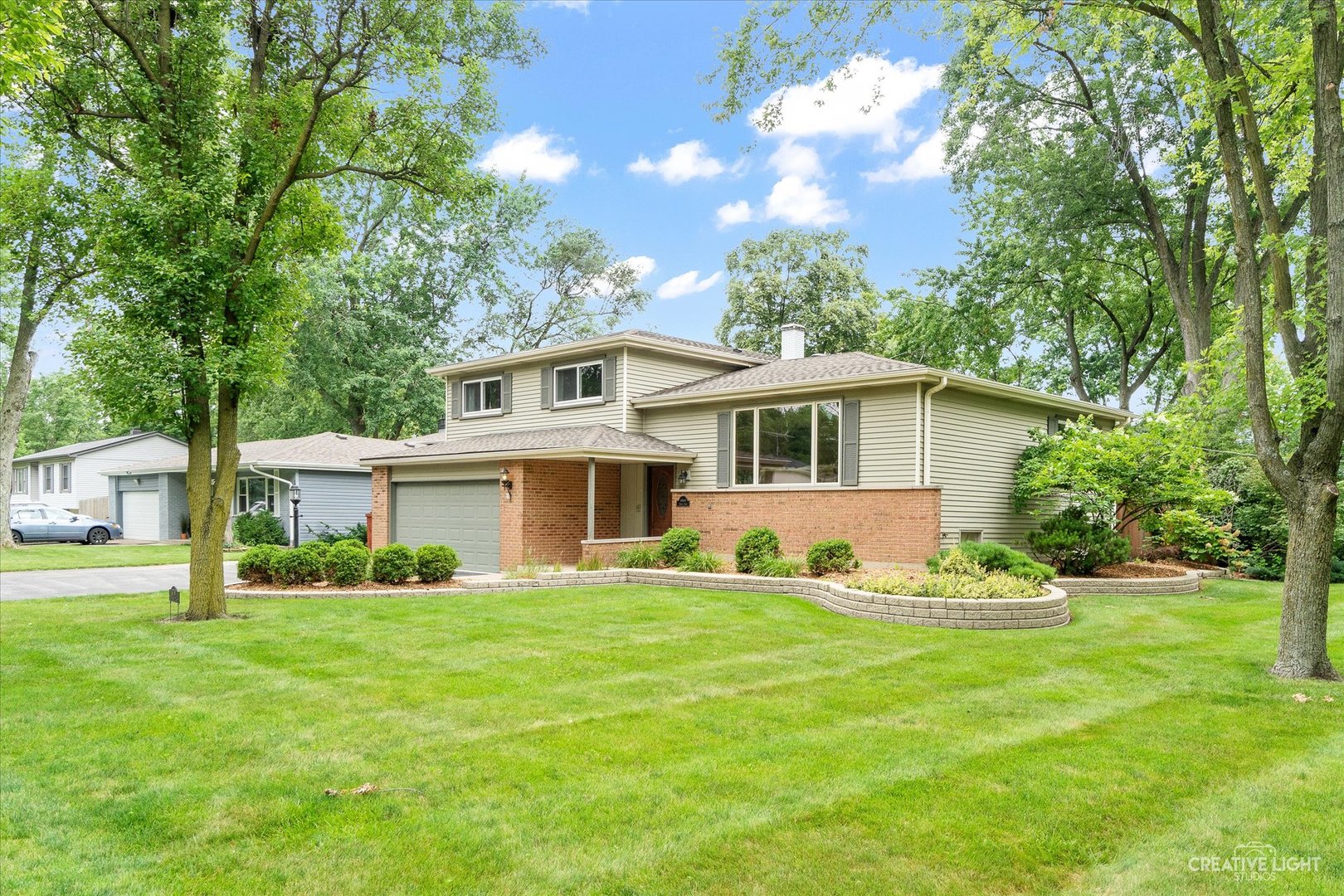 a front view of house with yard and green space