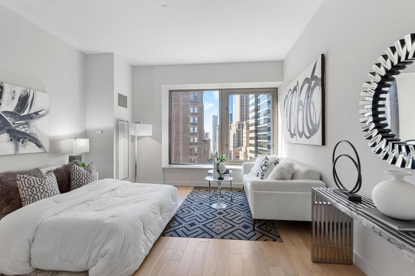 a spacious bedroom with a bed and glass windows