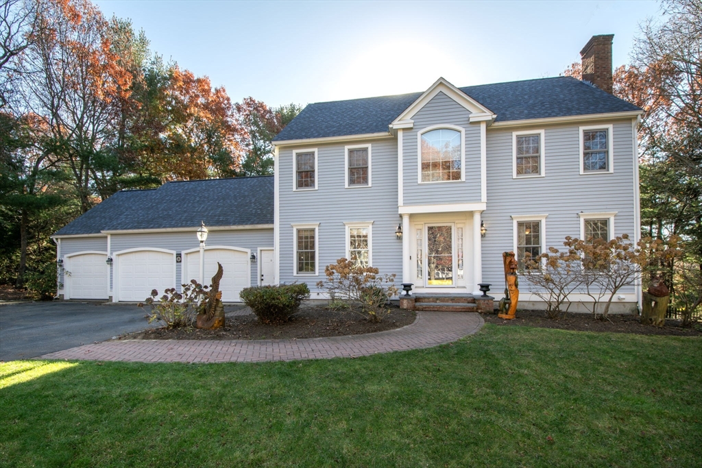 a front view of house with yard and outdoor seating