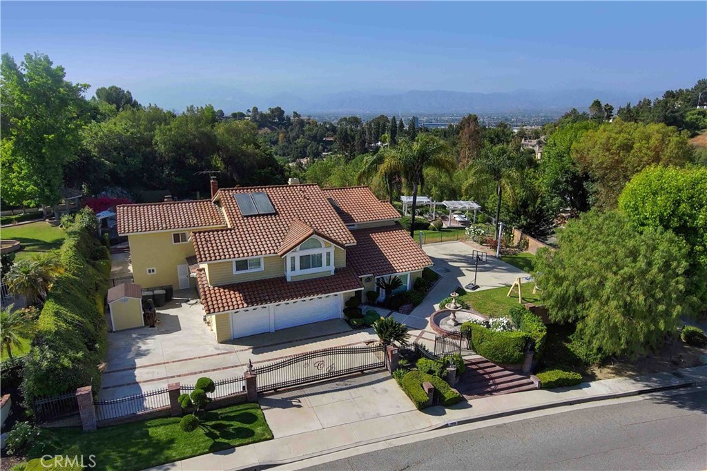 an aerial view of a house with a yard basket ball court and outdoor seating