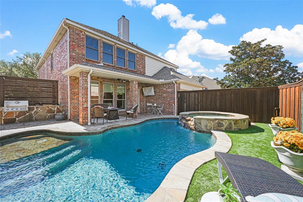 a view of a house with swimming pool and sitting area