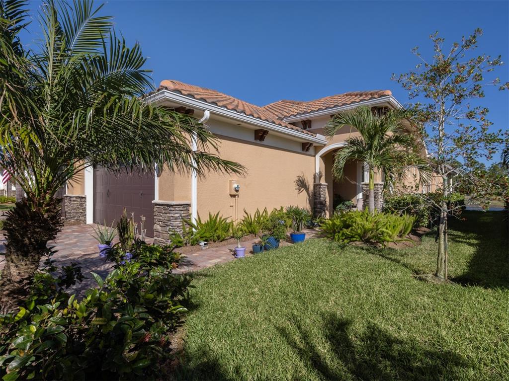 a front view of a house with a garden