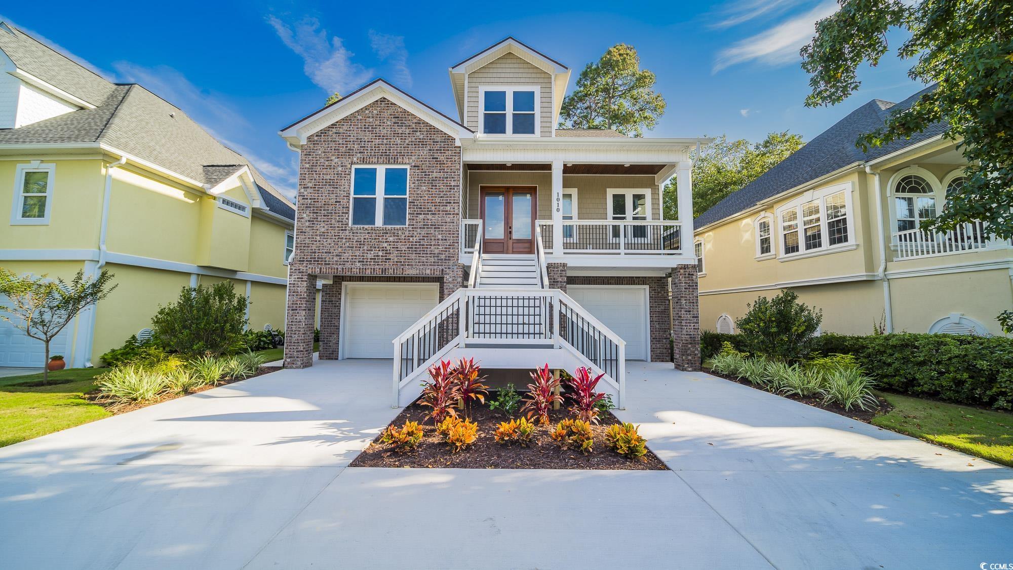 View of front of house featuring a garage and cove