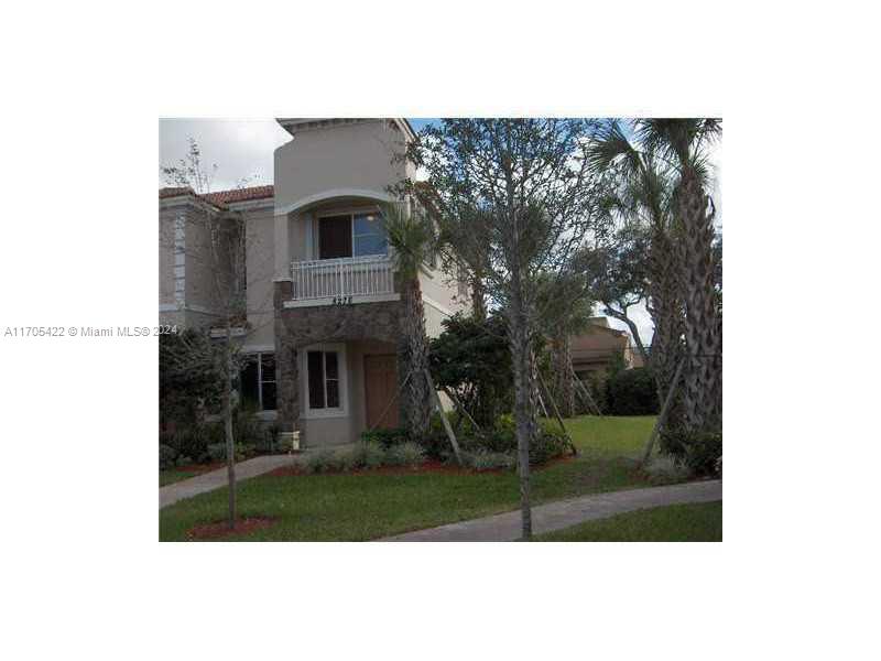 a view of house in front with a garden