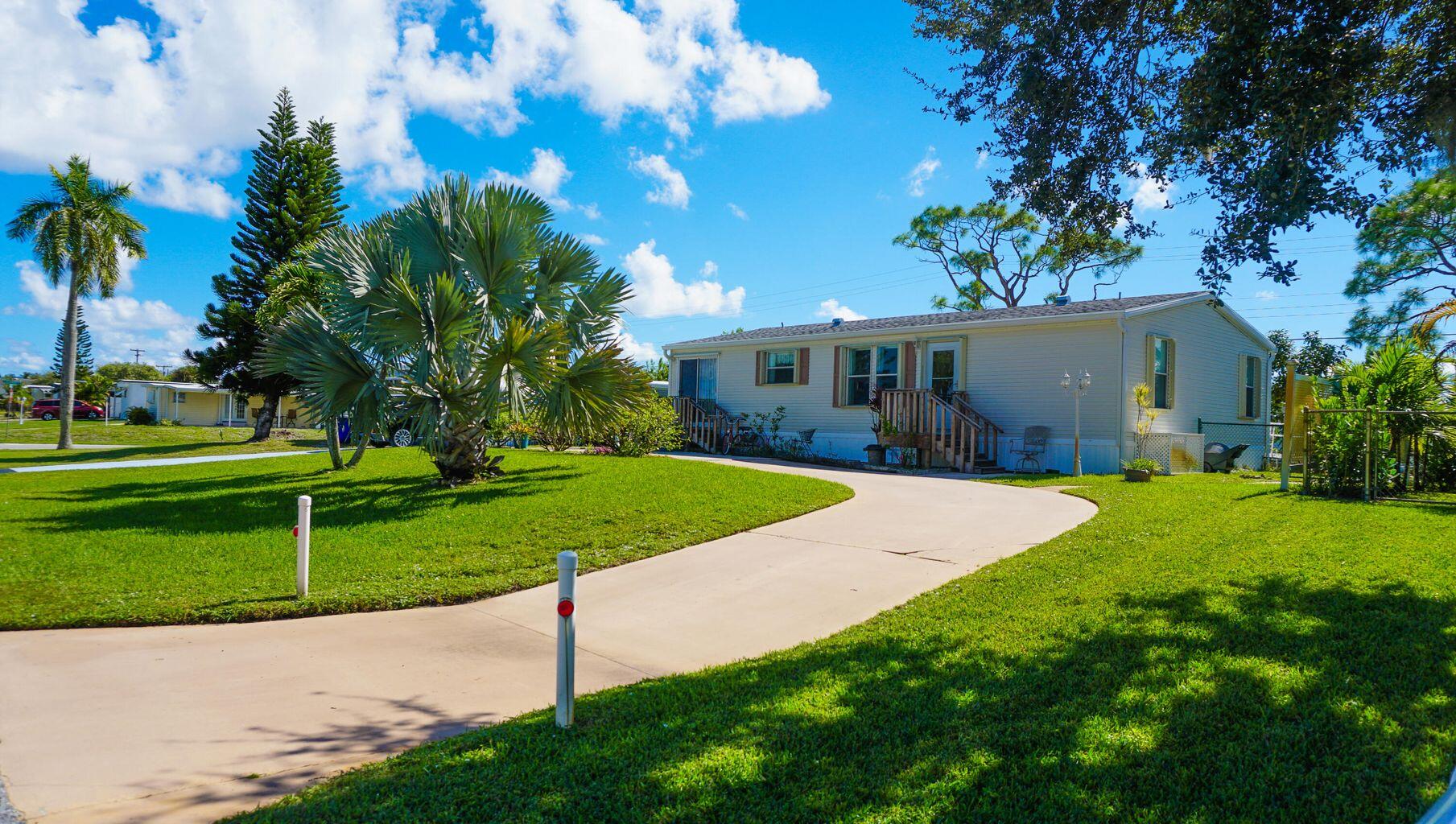 a view of a house with a yard and tree s