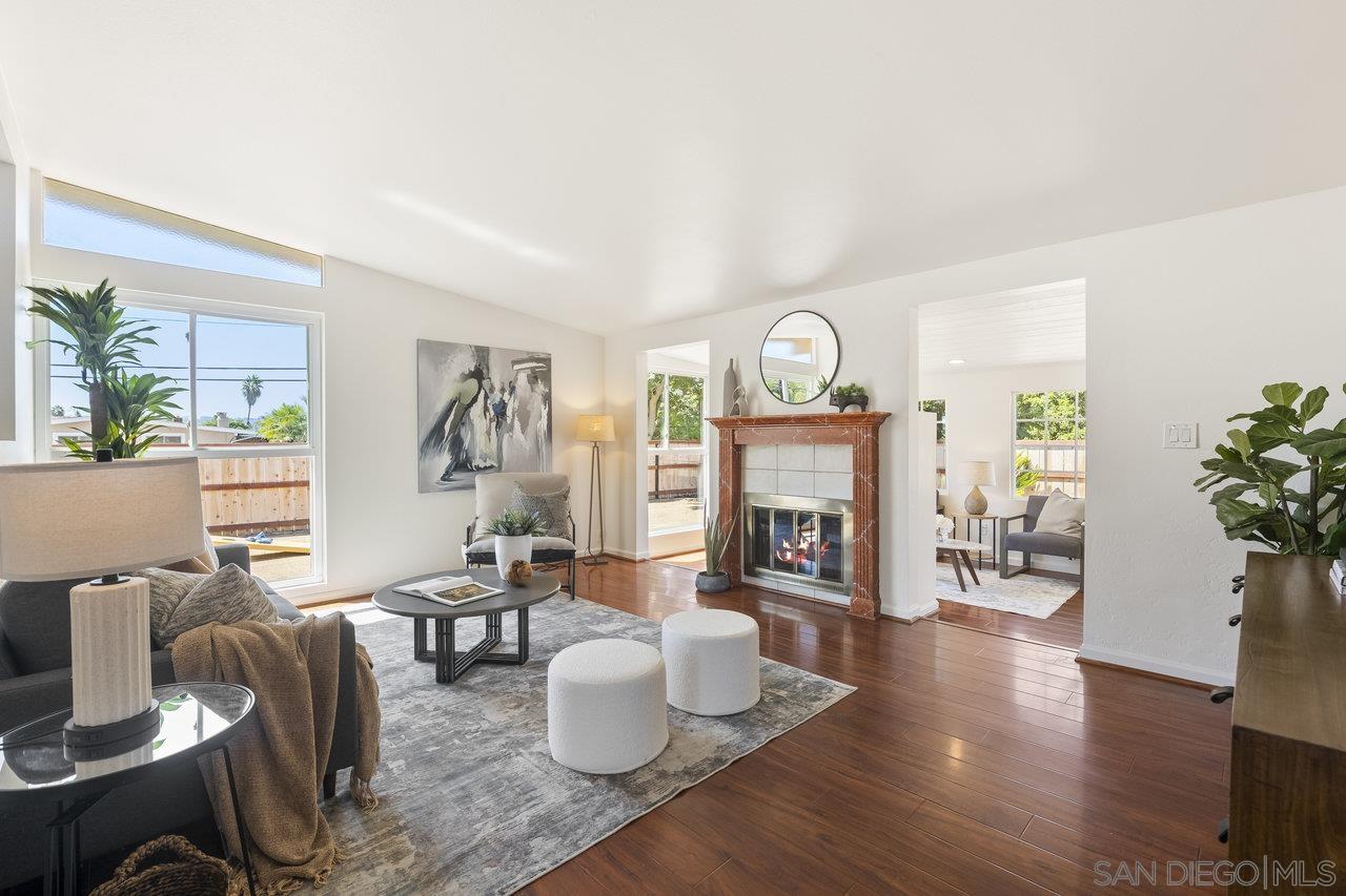 a living room with furniture a fireplace and a potted plant