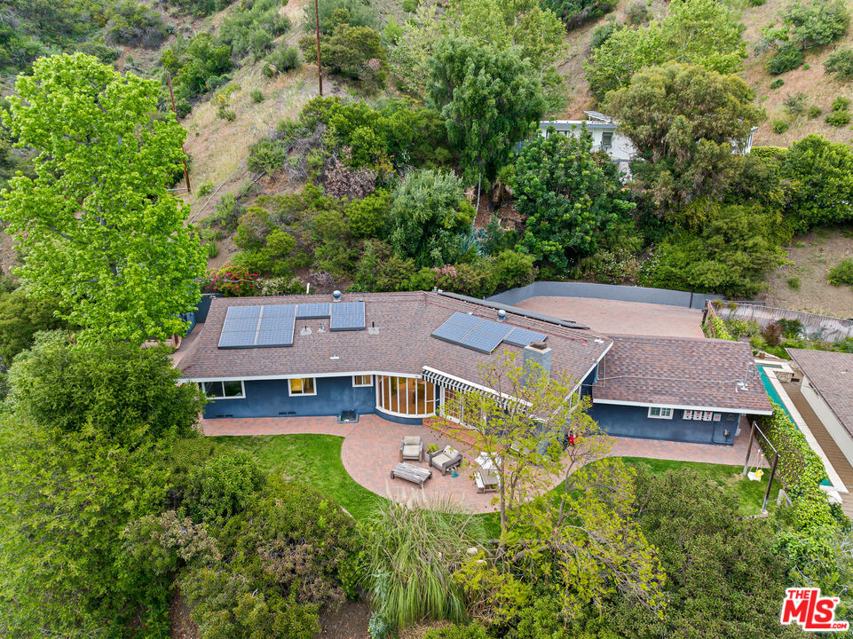 an aerial view of a house with garden space and a view of a house