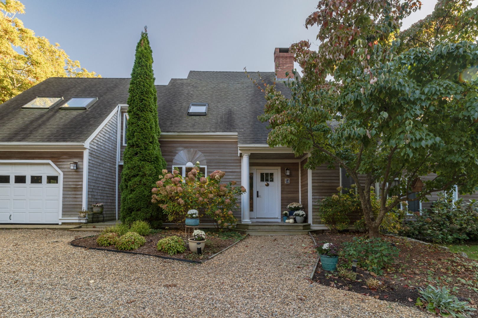 a front view of a house with garden