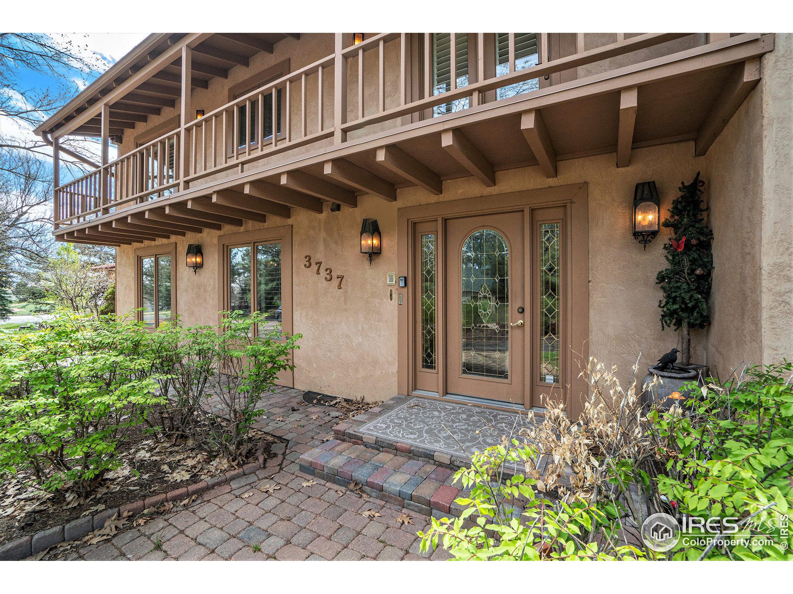 a view of a house with a flower garden