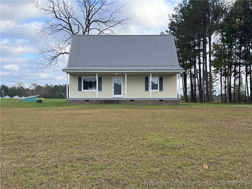 a front view of house with yard and lake view