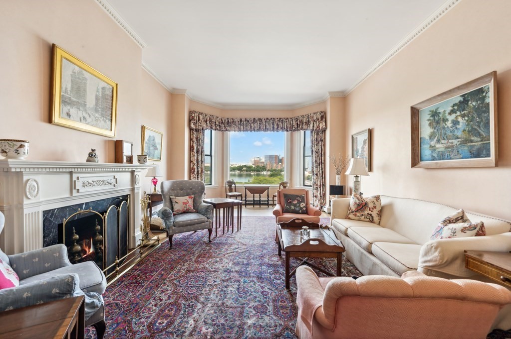 a living room with furniture large window and a fireplace