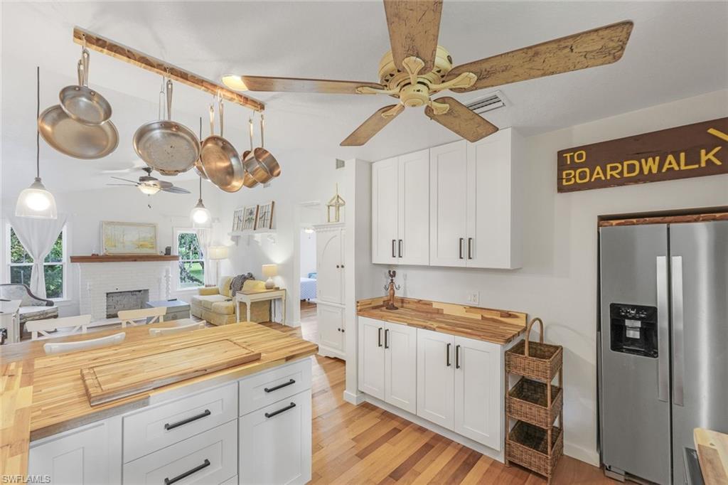 a kitchen with cabinets and wooden floor