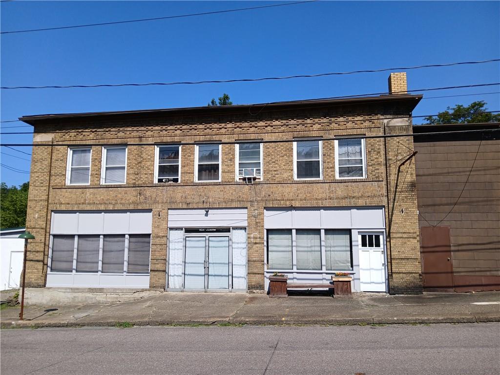 a front view of a building with a road