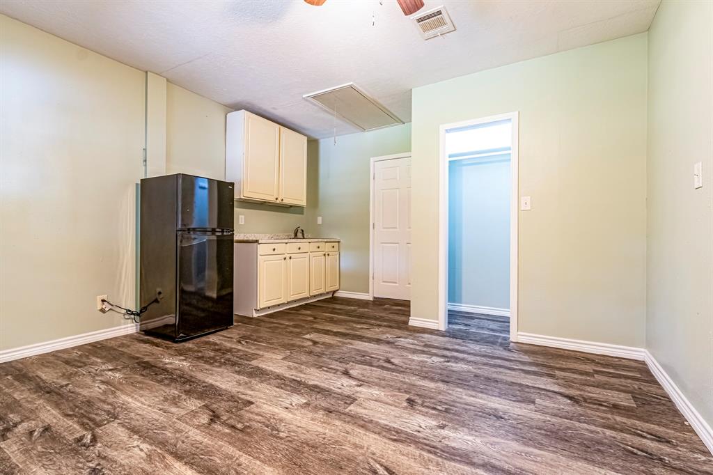 a view of a refrigerator in kitchen and a sink