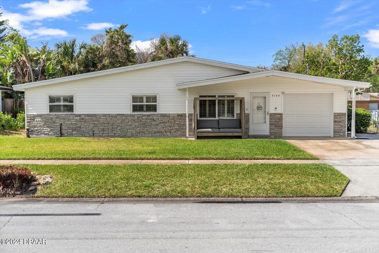 a front view of house with yard and green space