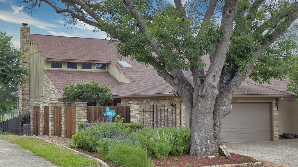 front view of a house with a tree