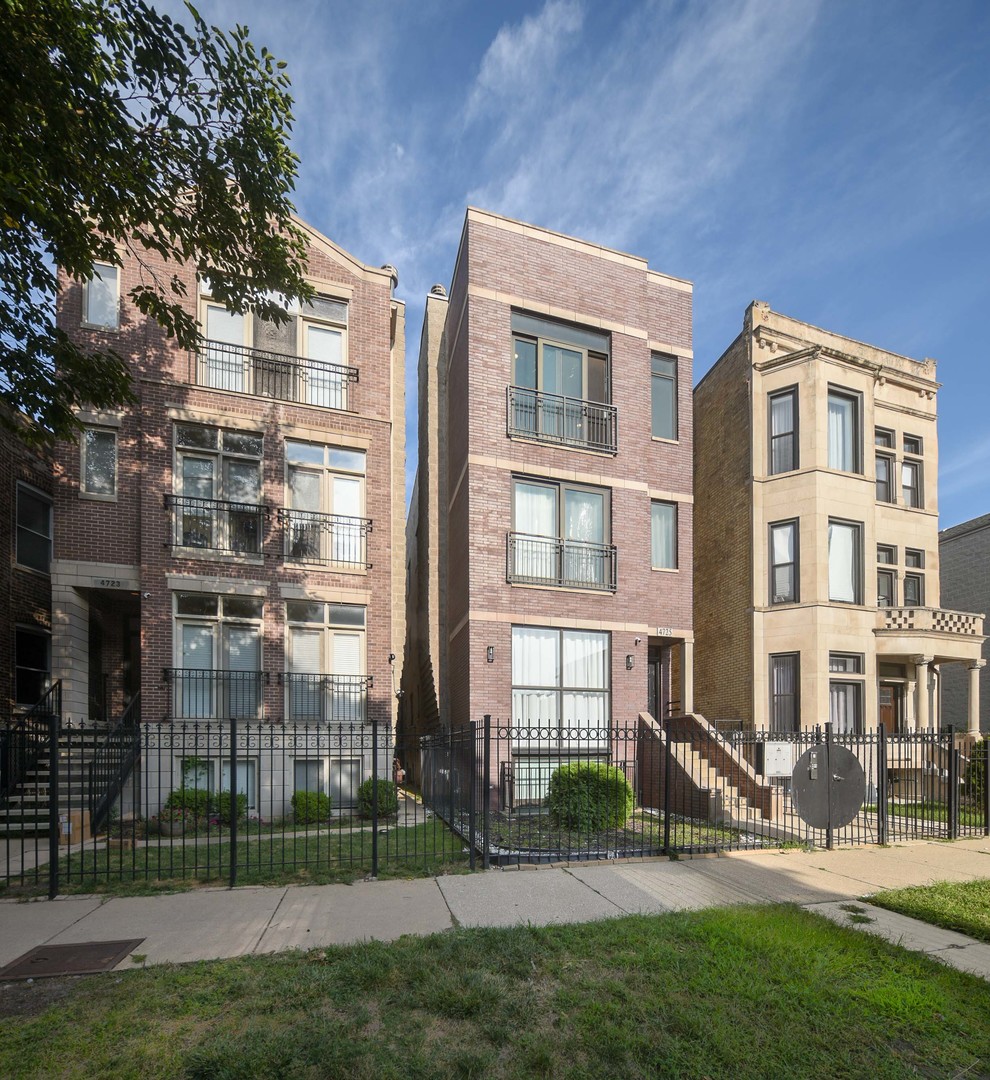 a view of a brick building next to a yard