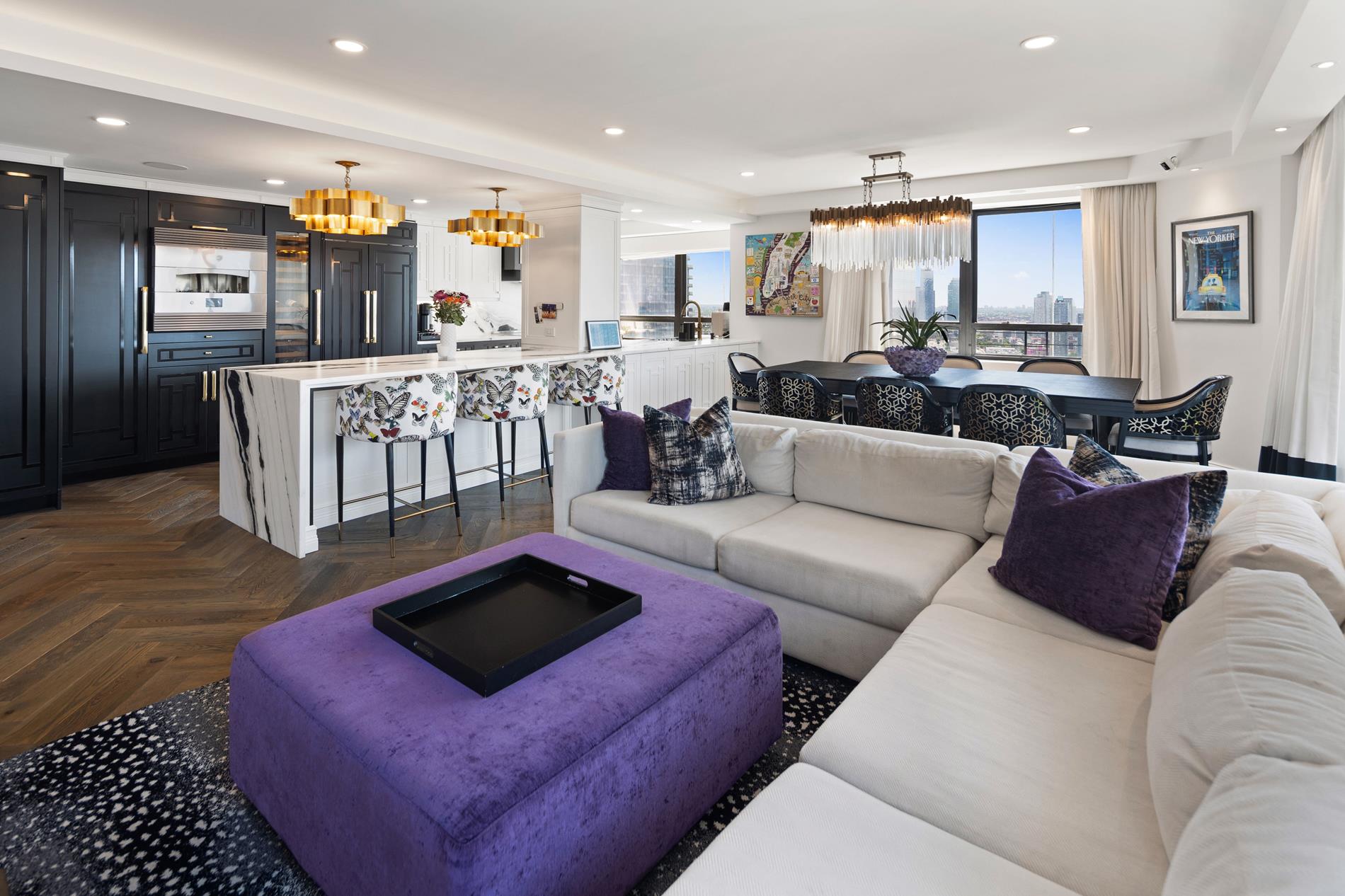 a living room with furniture and kitchen view