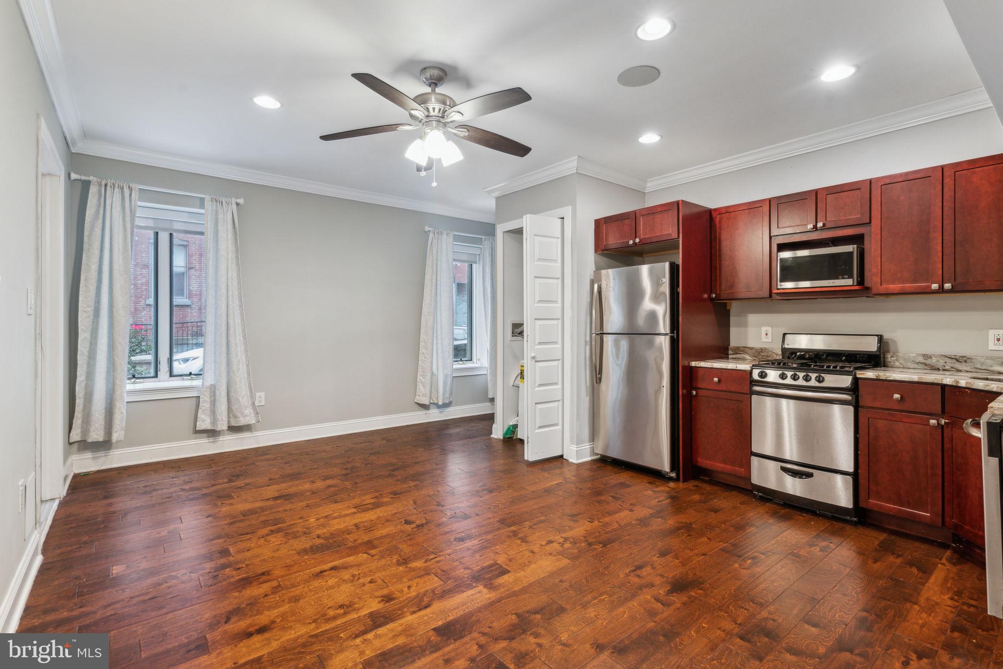 a kitchen with stainless steel appliances a refrigerator stove and microwave