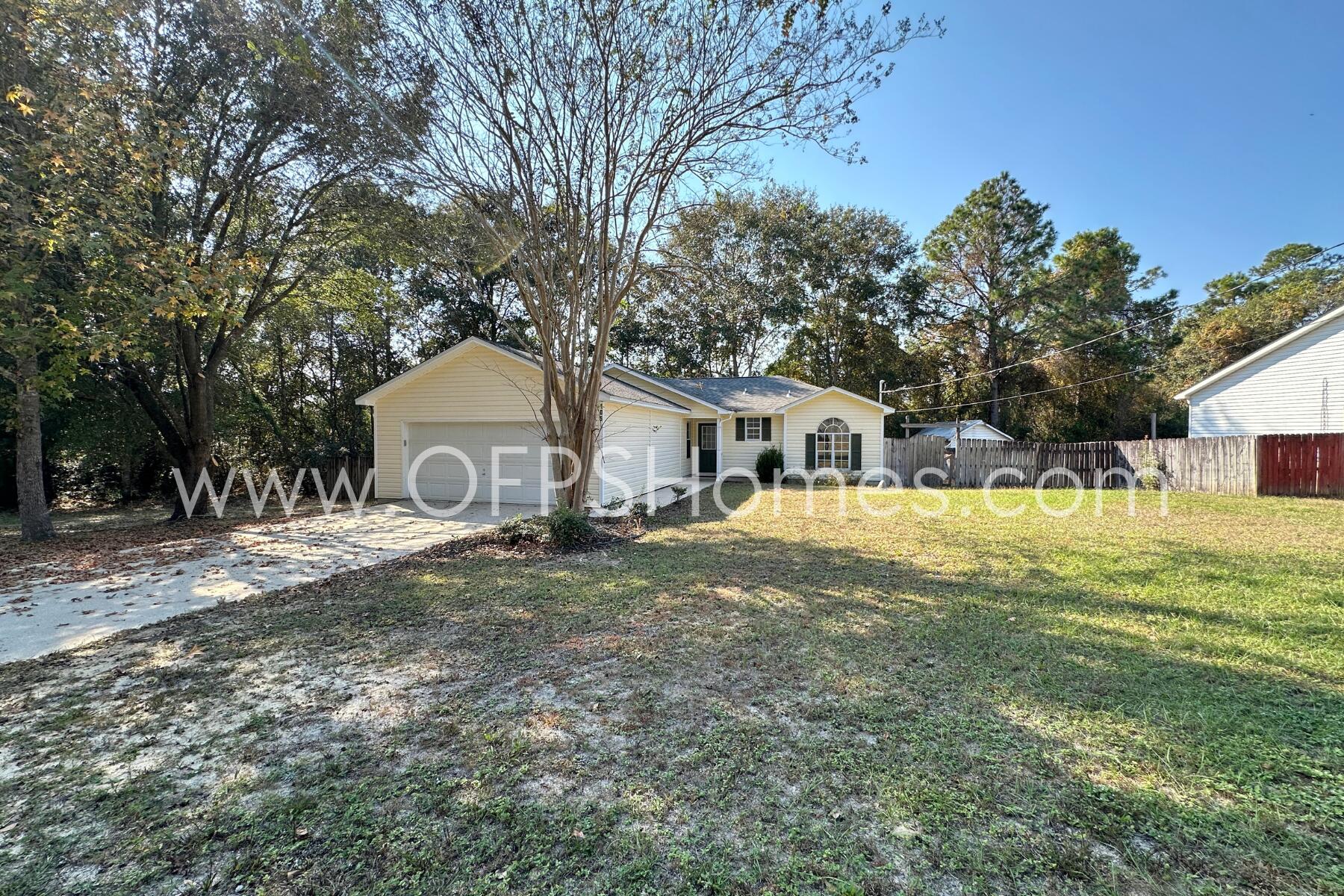 a front view of house with yard and trees