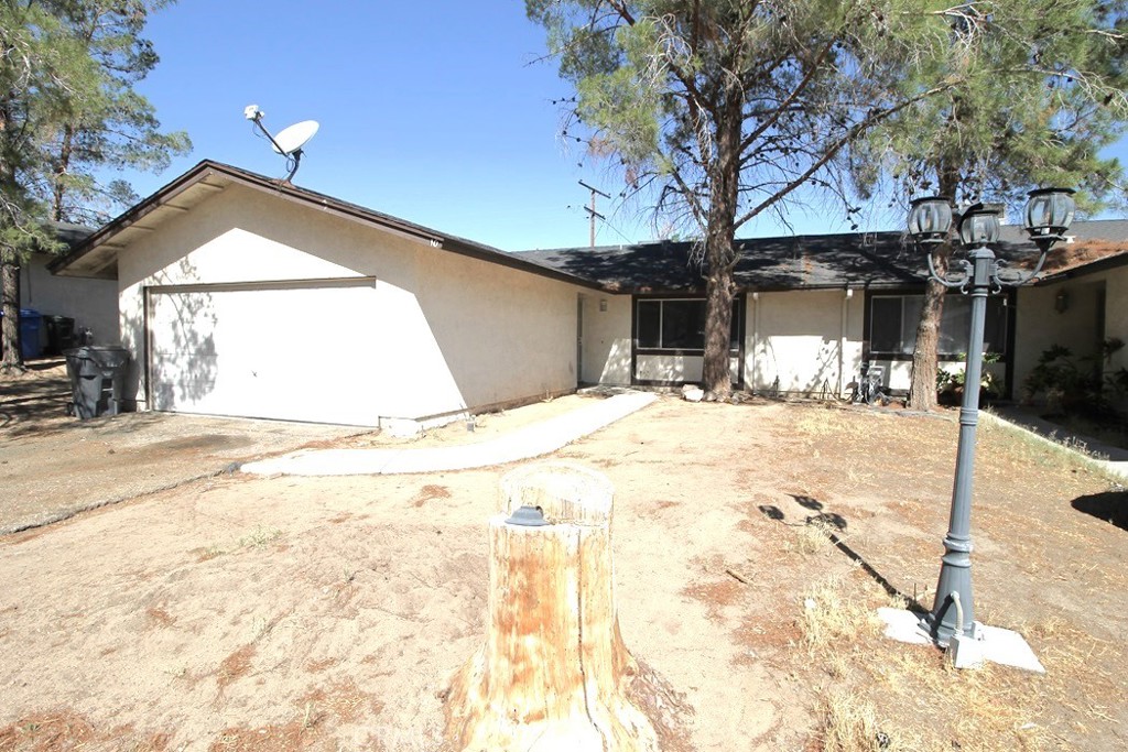 a view of garage with a tree