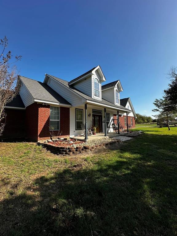 a view of a house with backyard and sitting area