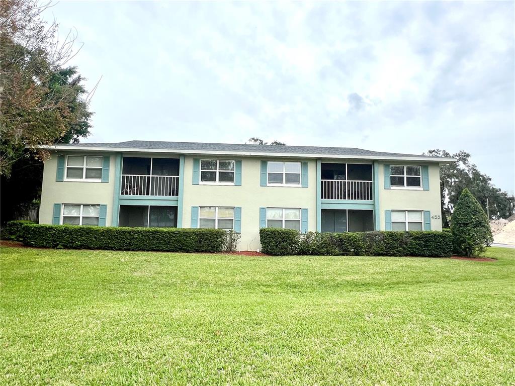 a front view of house with yard and green space