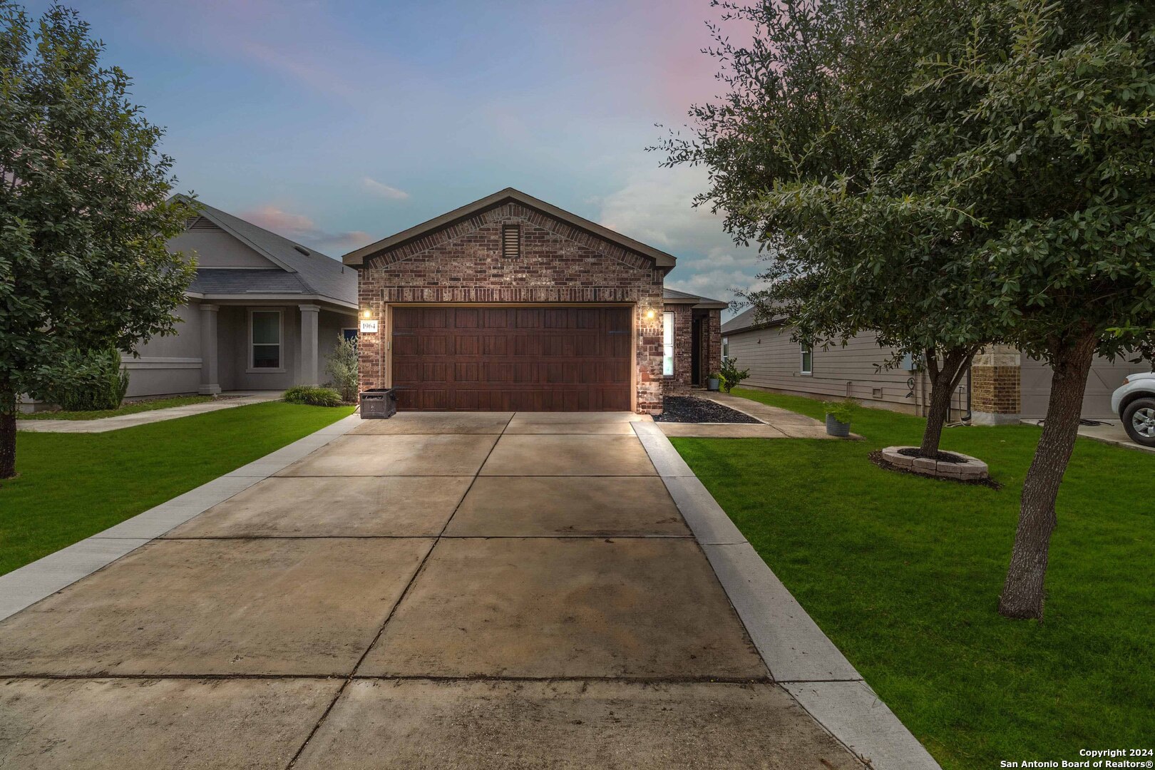 a front view of house with yard and green space