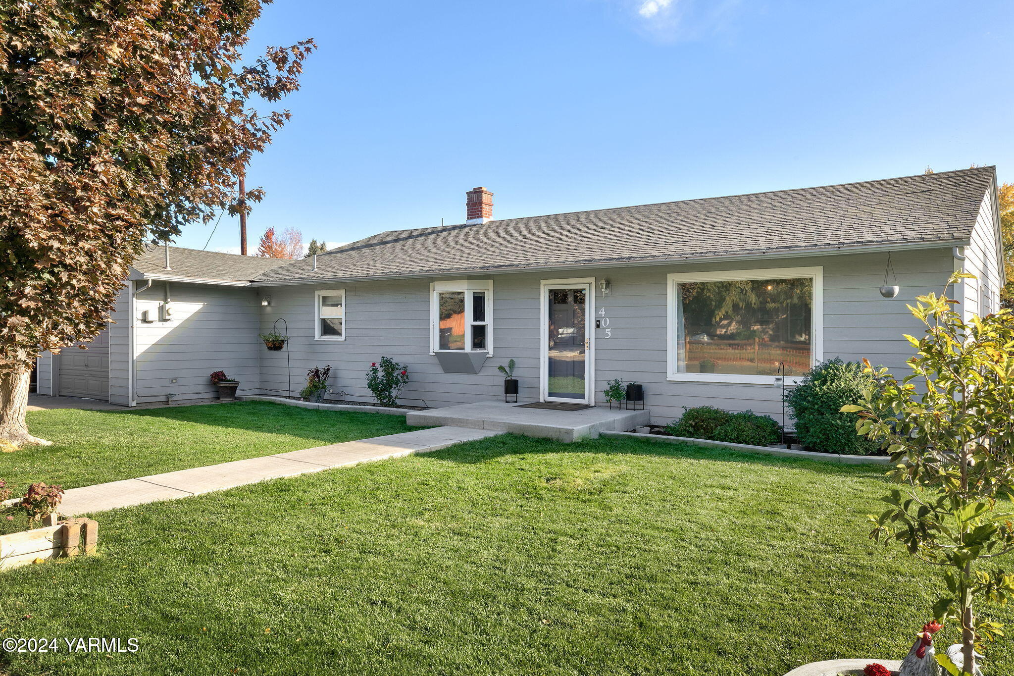 a front view of house with a garden and patio