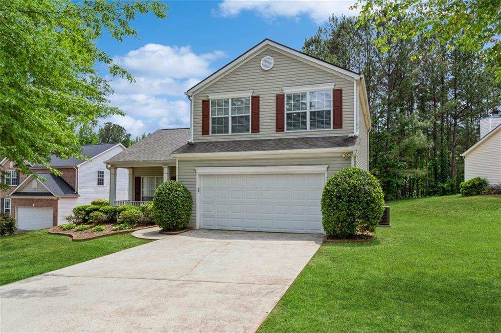 a front view of a house with a yard and garage