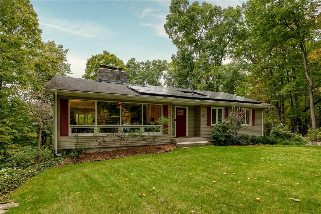 a front view of house with yard and green space