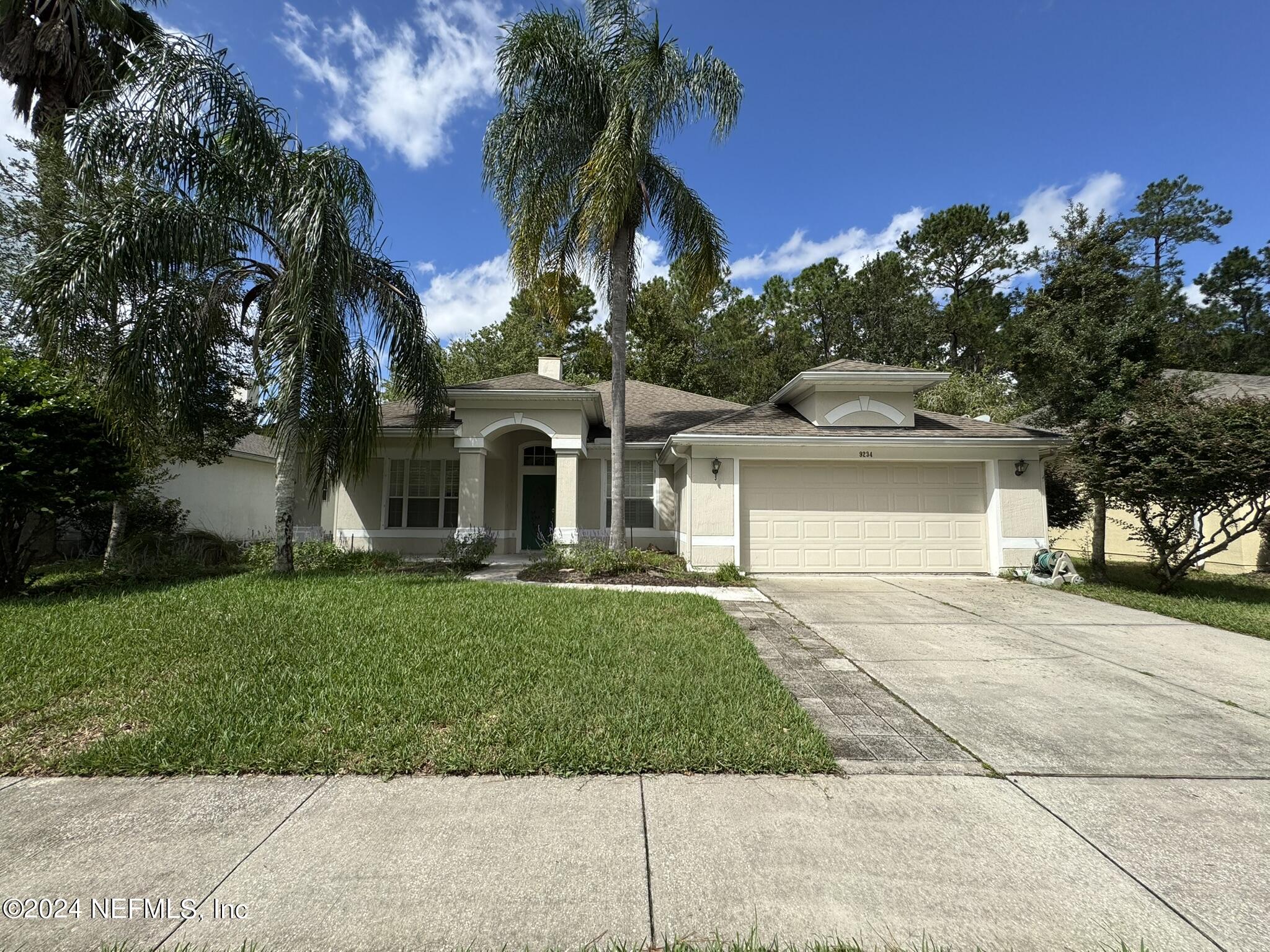 front view of a house with a garden