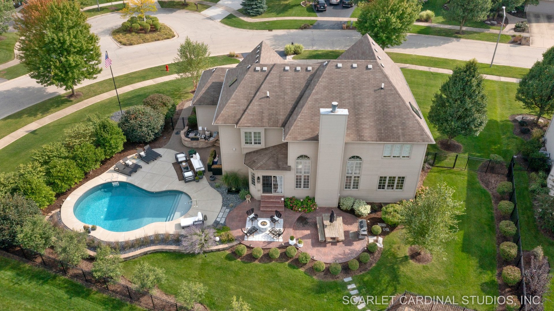 an aerial view of a house with outdoor space pool seating area and yard