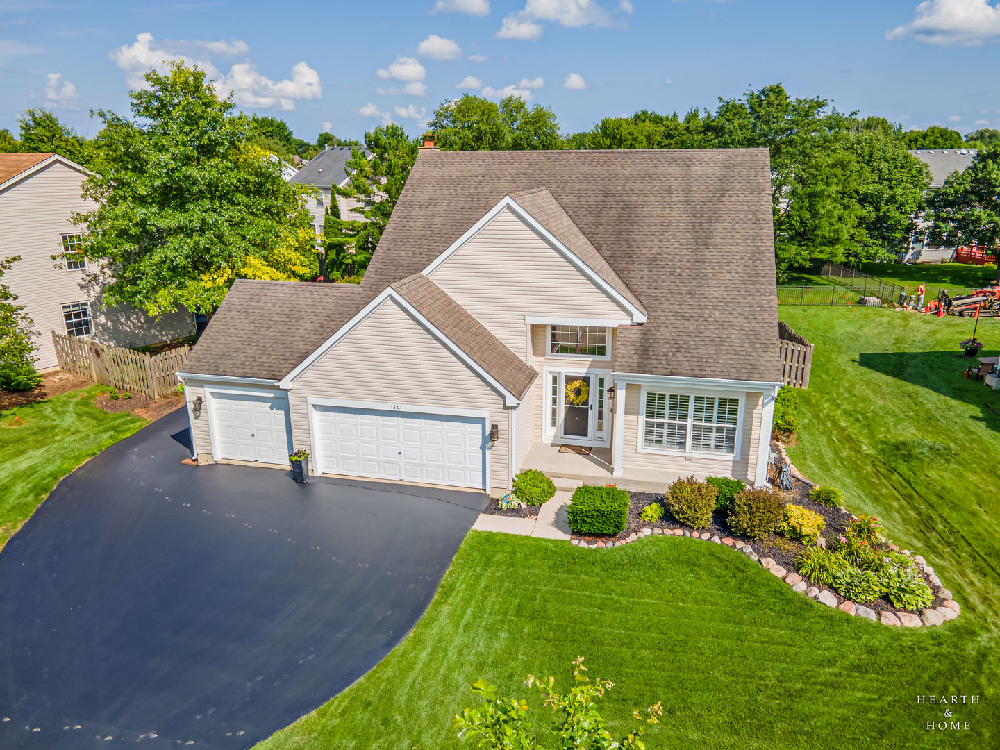 a aerial view of a house next to a yard