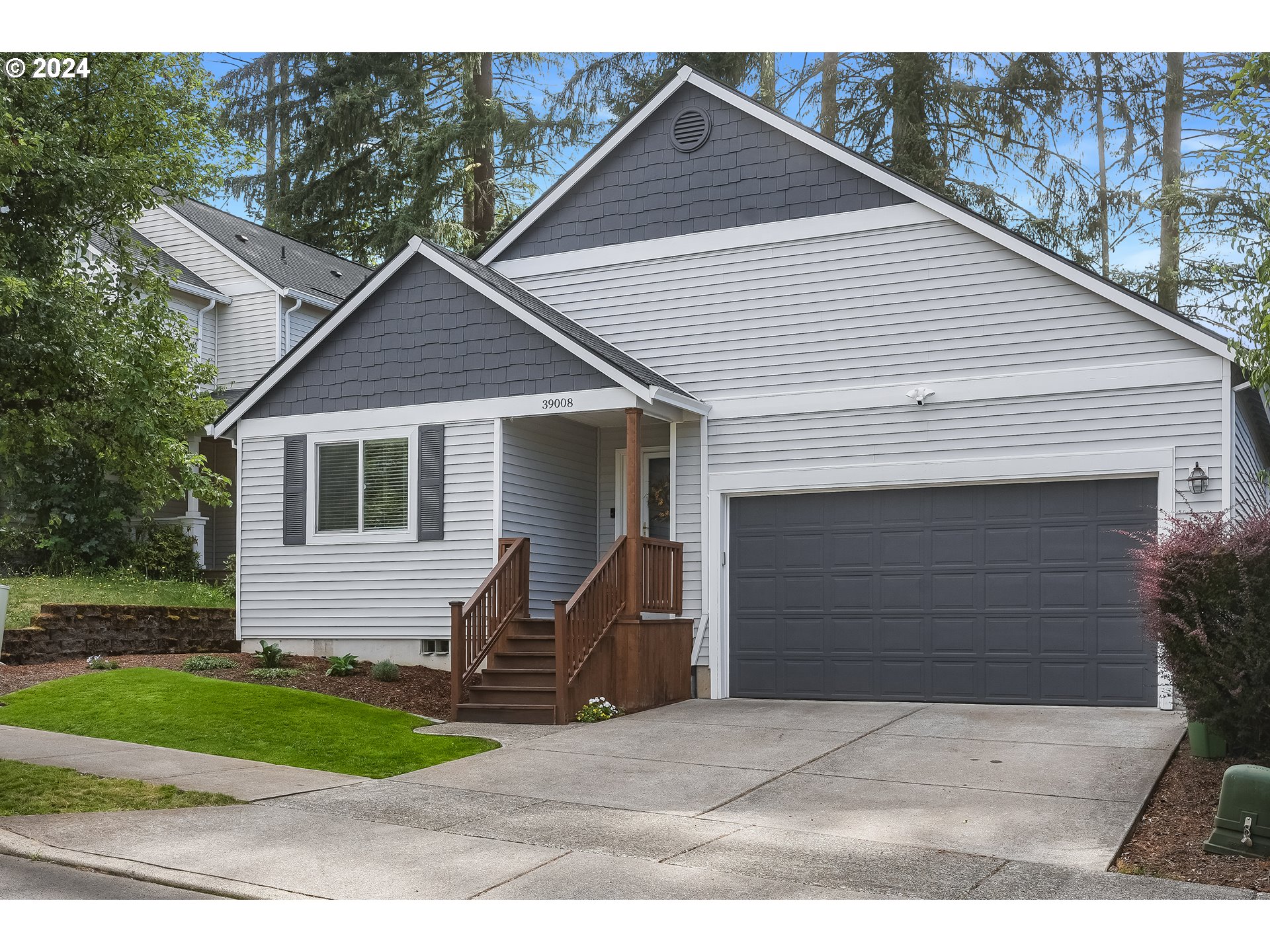 a view of house with a yard and garage