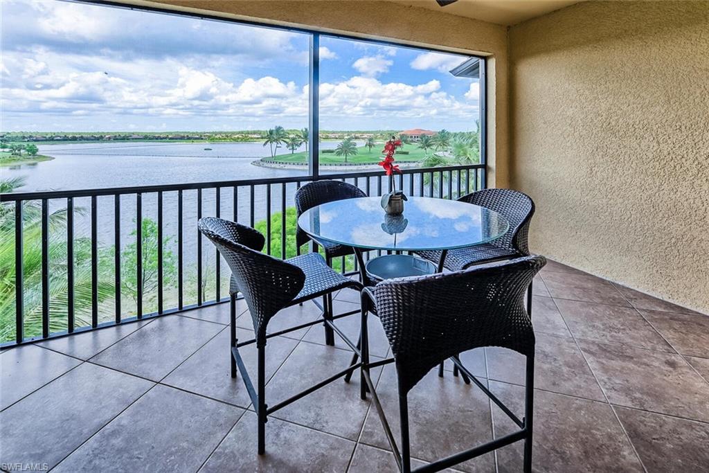 a view of a balcony with table and chairs