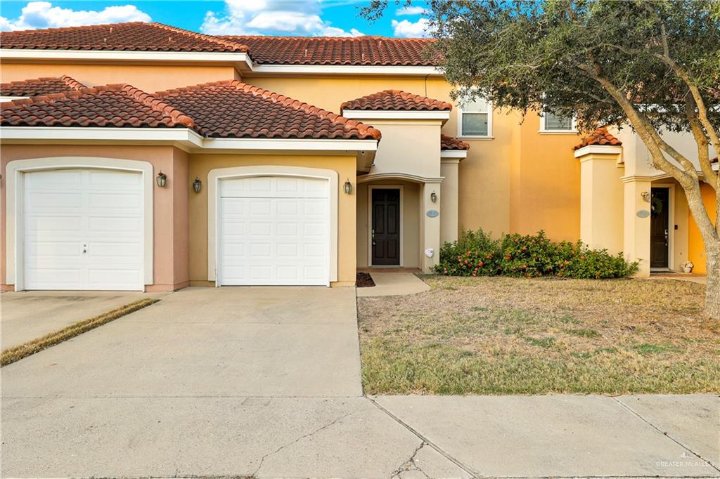 a front view of a house with a yard and garage