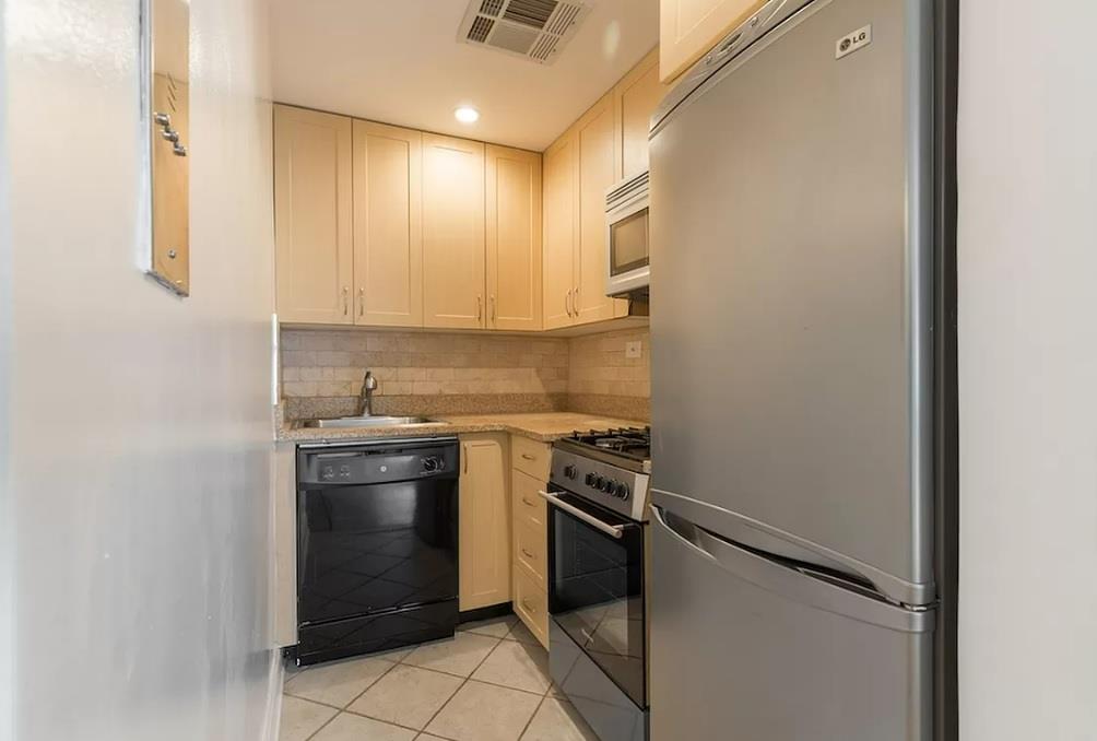 a kitchen with a stove cabinets and refrigerator