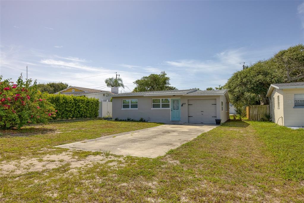 a front view of a house with a yard and a garage