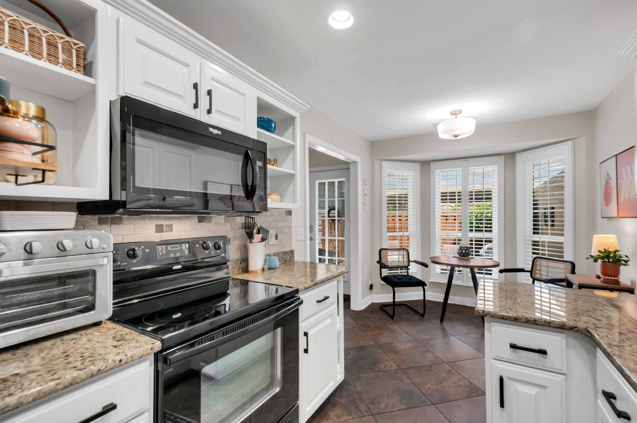 a kitchen with stainless steel appliances kitchen island granite countertop a stove and a sink