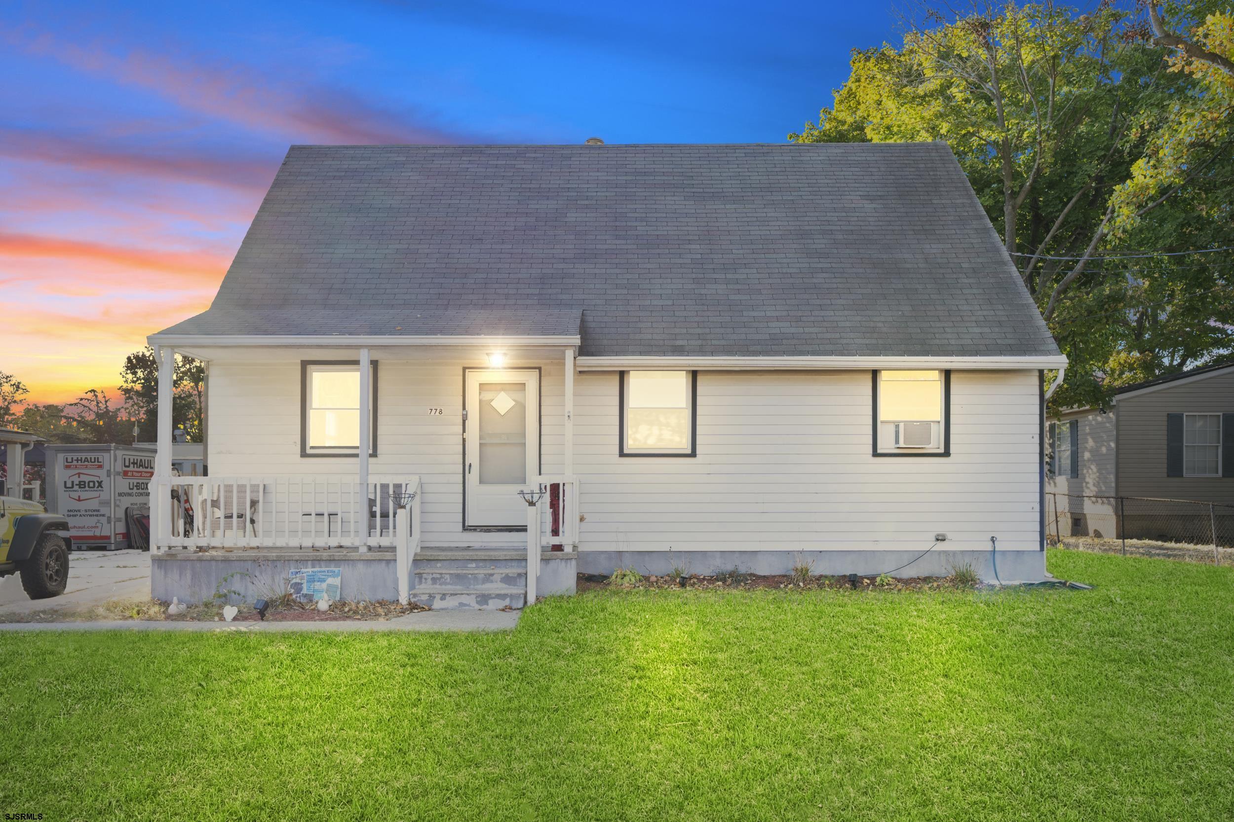 a front view of house with yard and outdoor seating