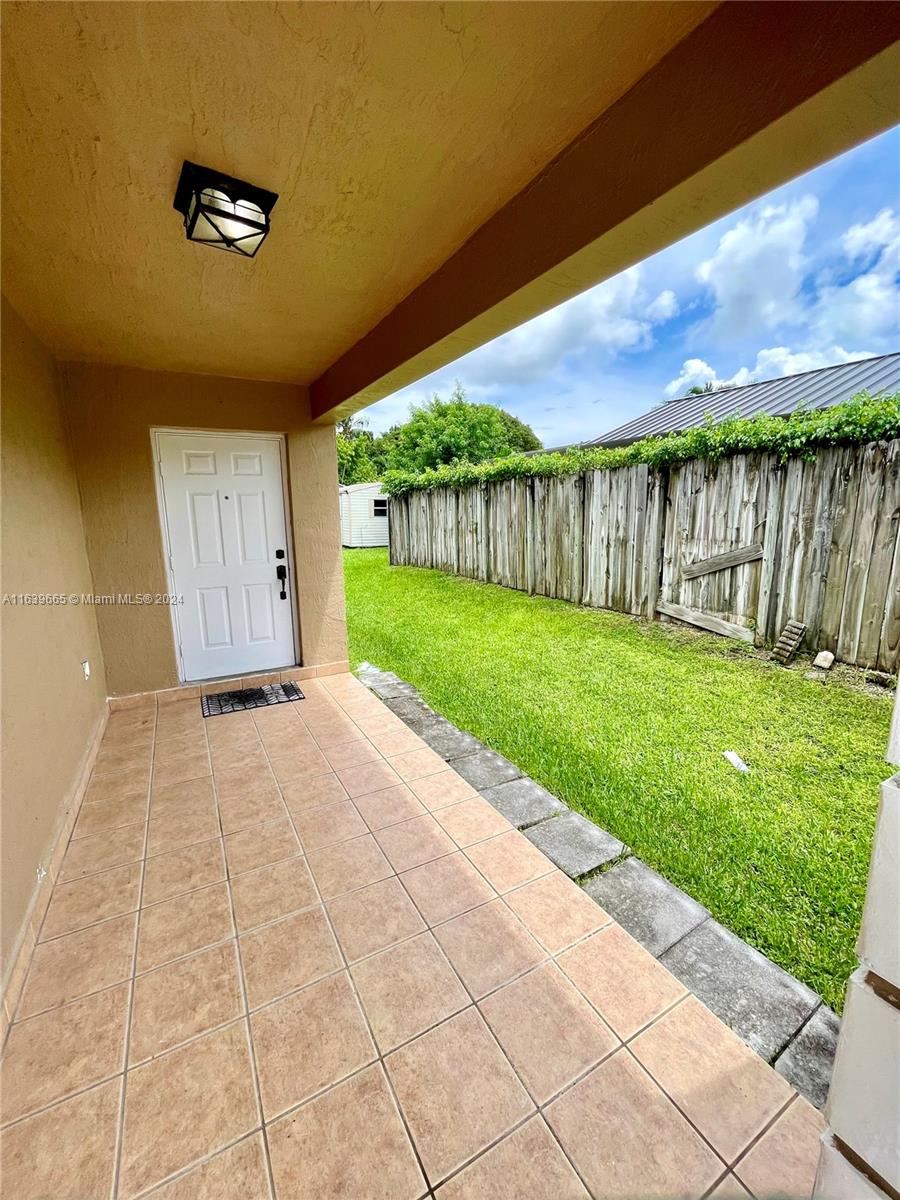 a view of backyard with tub and trees in the background