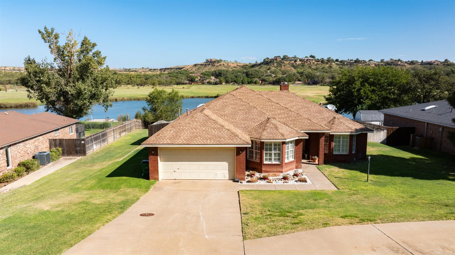 a aerial view of a house with swimming pool and a yard