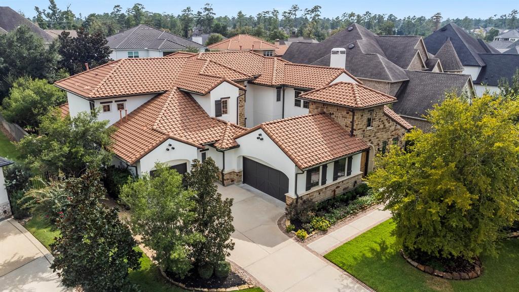 an aerial view of a house with yard and green space