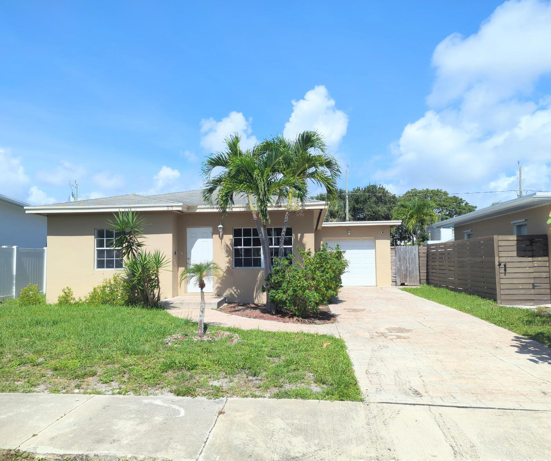 a front view of a house with a yard and a garage