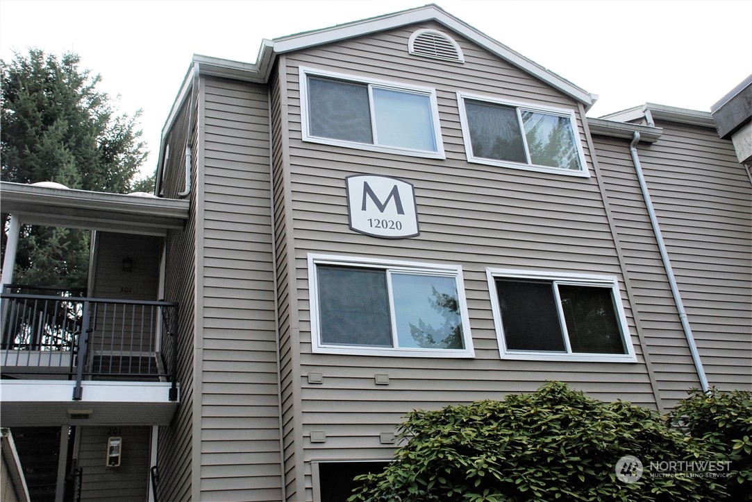 a front view of a house with plants